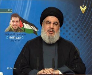 An image grab taken from Hezbollah's al-Manar TV on December 27, 2015, shows Hassan Nasrallah, the head of Lebanon's militant Shiite Muslim movement Hezbollah, giving a televised address from an undisclosed location in Lebanon on the one-week anniversary of the killing of Samir Kantar (portrait-L), one of the party's top militants, in a suspected Israeli air strike in Damascus.  AFP PHOTO / HO / AL-MANAR    === RESTRICTED TO EDITORIAL USE - MANDATORY CREDIT "AFP PHOTO / HO / AL-MANAR" - NO MARKETING NO ADVERTISING CAMPAIGNS - DISTRIBUTED AS A SERVICE TO CLIENTS ===